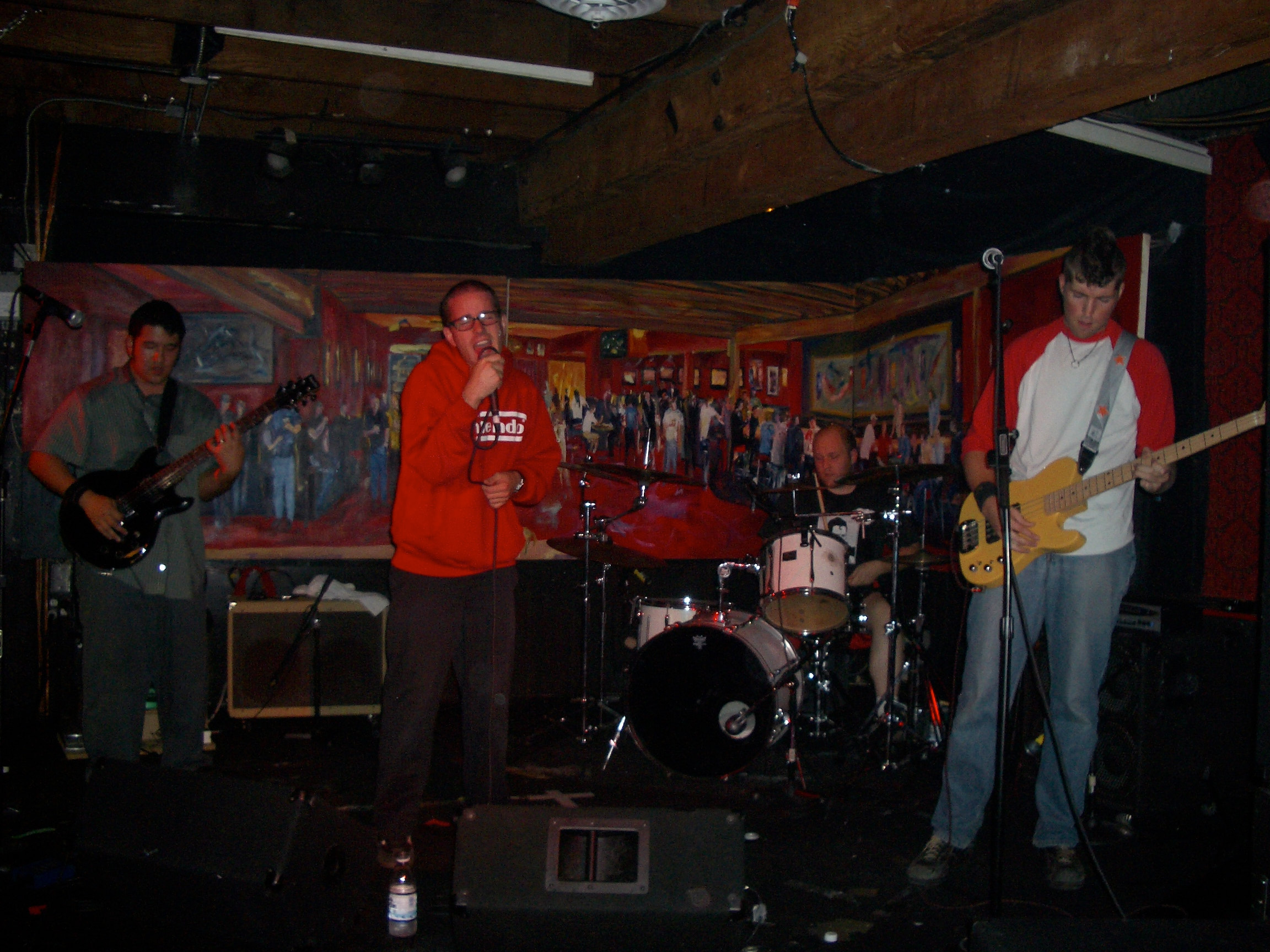 the band playing a show at a bar