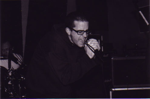 black and white photo of singing and drumming