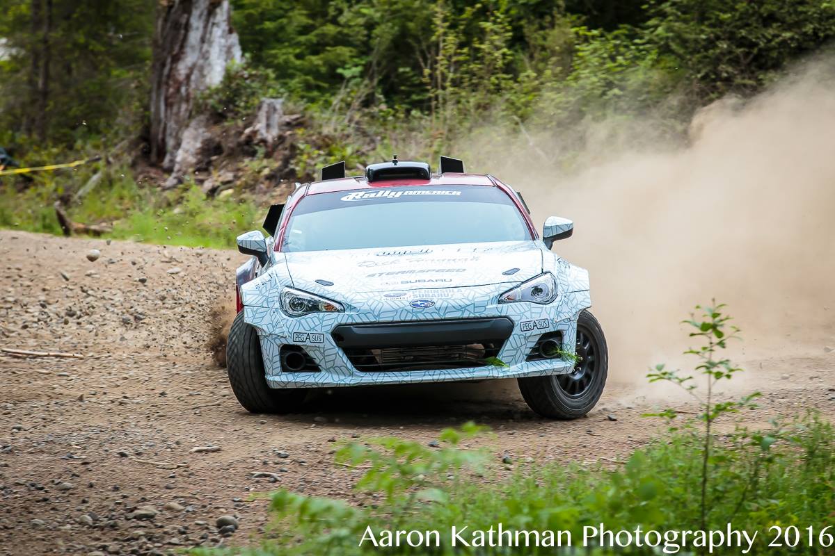 a subaru brz rally car slides by the camera very sideways